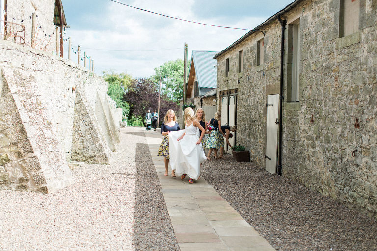 boho bride walks to aisle to greet father at doxford barns