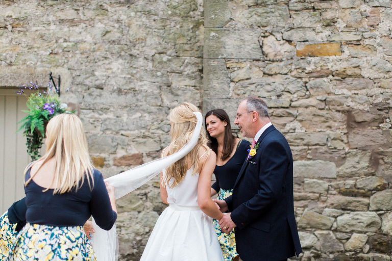 stylish bride greets father at doxford barns