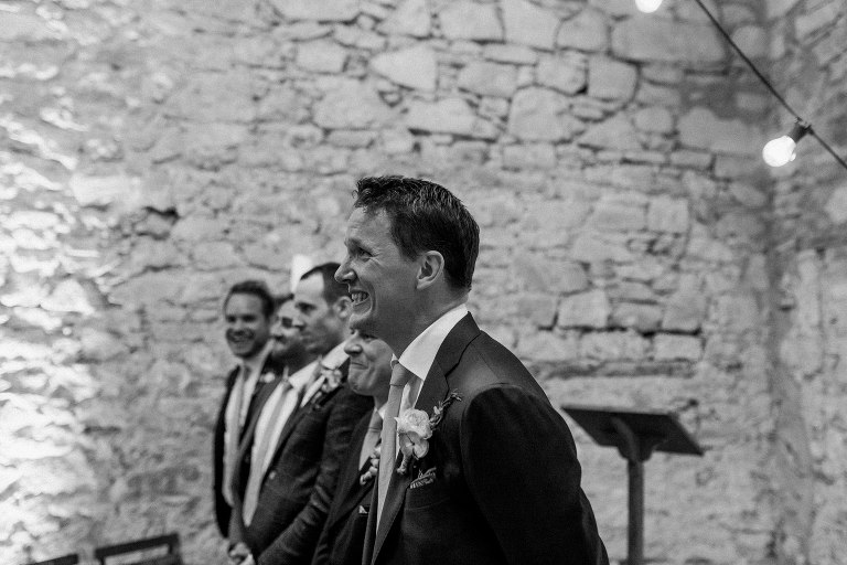 stylish groom sees bride for first time at the threshing hall at doxford barns