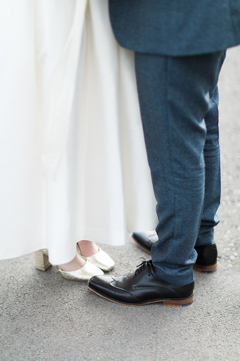 a closeup of bride and grooms shoes